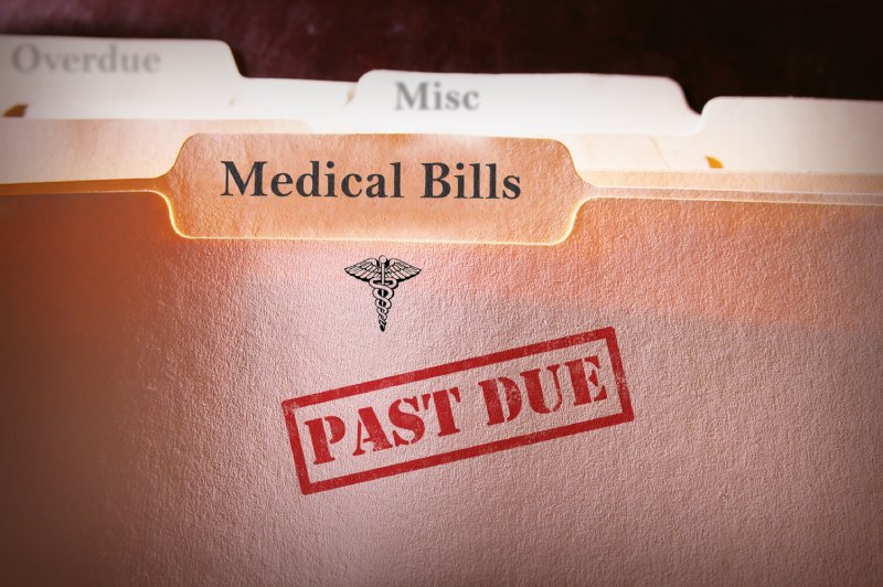 A folder with Medical Bills written on it, and a stamp that says Past Due