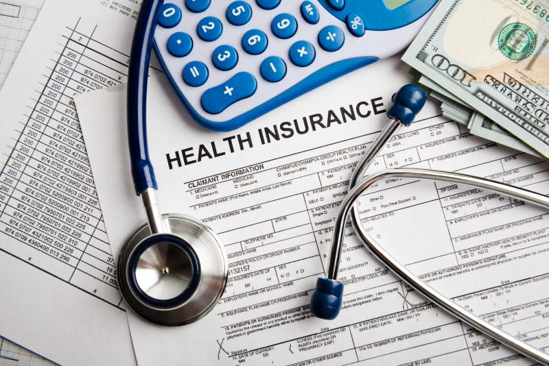 Health insurance form with a stethoscope and cash