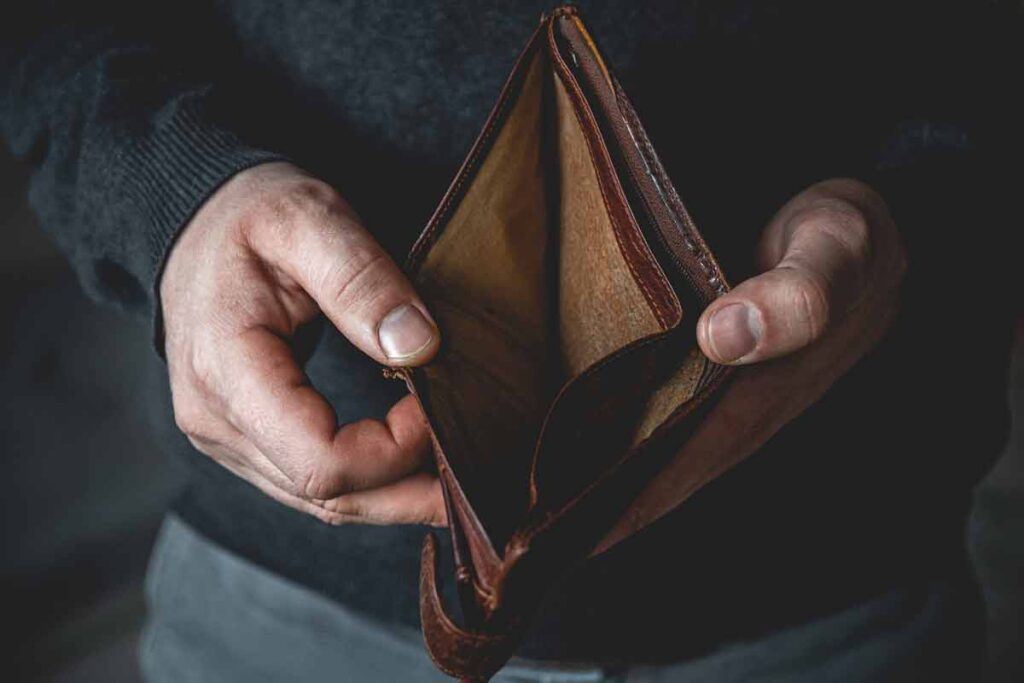 A man holding open an empty wallet