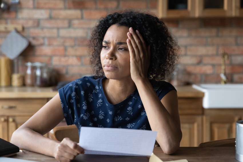 A stressed woman looking at a medical bill