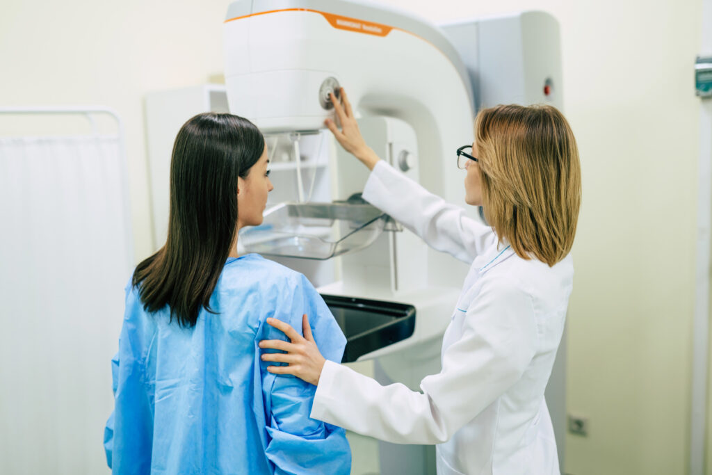 A female healthcare worker giving a woman a mammogram. iStock Povozniuk